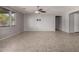 Light filled living room featuring neutral paint, tile floors, and a ceiling fan at 3254 N Park St, Buckeye, AZ 85396