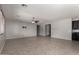 Spacious living room featuring neutral paint, tile floors, and a ceiling fan at 3254 N Park St, Buckeye, AZ 85396