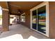 A covered patio, featuring a ceiling fan and a sliding glass door at 3254 N Park St, Buckeye, AZ 85396