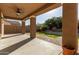 Covered outdoor patio with ceiling fan, brick and concrete flooring, and backyard view at 3254 N Park St, Buckeye, AZ 85396