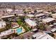 Aerial of an apartment complex with a pool, playground, and parking areas, surrounded by greenery and residential streets at 3601 W Tierra Buena Ln # 233, Phoenix, AZ 85053