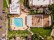 Aerial view displaying community amenities including pool, lounge area, and playground surrounded by landscaped grounds and palm trees at 3601 W Tierra Buena Ln # 233, Phoenix, AZ 85053