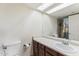 Bathroom featuring vanity with storage, ample counter space, and toilet at 3601 W Tierra Buena Ln # 233, Phoenix, AZ 85053