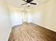 An empty room with wood-look floors and ceiling fan offers flexible living space at 3601 W Tierra Buena Ln # 233, Phoenix, AZ 85053