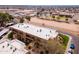 Aerial shot of a tidy apartment building with well-maintained green spaces, surrounded by street and neighborhood amenities at 3601 W Tierra Buena Ln # 233, Phoenix, AZ 85053