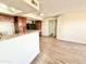 Kitchen featuring breakfast bar and wood cabinets flowing into an open living area at 3601 W Tierra Buena Ln # 233, Phoenix, AZ 85053