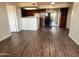 Open living space featuring wood-look floors and a kitchen with dark cabinets at 3601 W Tierra Buena Ln # 233, Phoenix, AZ 85053
