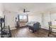 Comfortable living room with a ceiling fan, stylish flooring, and ample natural light streaming through the window at 3601 W Tierra Buena Ln # 233, Phoenix, AZ 85053