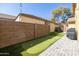 A backyard featuring a putting green with green artificial turf, surrounded by a block fence at 3840 E Yeager Dr, Gilbert, AZ 85295