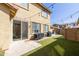 Relaxing backyard featuring green artificial grass, a patio, string lights and a built-in grill at 3840 E Yeager Dr, Gilbert, AZ 85295