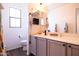 Bright bathroom features white cabinets, a modern sink, and a decorative mirror at 3840 E Yeager Dr, Gilbert, AZ 85295