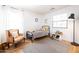 A bright bedroom featuring a cozy chair, natural light, and minimalist decor at 3840 E Yeager Dr, Gilbert, AZ 85295