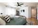 Bright bedroom featuring a black metal bedframe, ceiling fan and modern decor at 3840 E Yeager Dr, Gilbert, AZ 85295