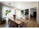 Bright dining room with a wooden table, seating for eight, large windows, and a built-in bookshelf at 3840 E Yeager Dr, Gilbert, AZ 85295