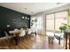 Sunlit dining area with a wooden table, seating for six, and a view of the backyard through sliding glass doors at 3840 E Yeager Dr, Gilbert, AZ 85295