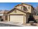 Lovely home exterior featuring a two-car garage, lush greenery, and well-kept landscaping at 3840 E Yeager Dr, Gilbert, AZ 85295