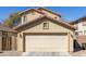 Home exterior featuring a two-car garage, neutral paint, and well-maintained landscaping at 3840 E Yeager Dr, Gilbert, AZ 85295