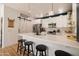 Modern kitchen with white cabinets, stainless steel appliances, a pantry door, and a breakfast bar with stools at 3840 E Yeager Dr, Gilbert, AZ 85295