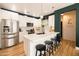 Well-lit kitchen with white cabinetry, stainless steel appliances, quartz countertops, and a breakfast bar with stools at 3840 E Yeager Dr, Gilbert, AZ 85295