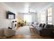 Inviting living room with shiplap accent wall, comfortable gray sectional, and lots of natural light at 3840 E Yeager Dr, Gilbert, AZ 85295