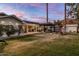 Expansive backyard with an outdoor kitchen, patio, pergola, and grassy area at 4111 N 52Nd St, Phoenix, AZ 85018