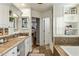 Bright bathroom with stone tile flooring, tub, and doorway to the main bedroom at 4111 N 52Nd St, Phoenix, AZ 85018