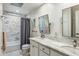 Well-lit bathroom featuring marble counters, tiled shower, and decorative mirror at 4111 N 52Nd St, Phoenix, AZ 85018