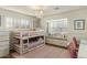 Cozy bedroom featuring bunkbeds, window seating, a stylish chandelier, and white trim at 4111 N 52Nd St, Phoenix, AZ 85018