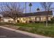 A charming home showcasing a lush front yard, covered porch, and appealing architectural details at 4111 N 52Nd St, Phoenix, AZ 85018