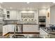 Bright kitchen with stainless steel appliances, black granite countertops, and a designer backsplash at 4111 N 52Nd St, Phoenix, AZ 85018