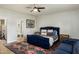 Spacious main bedroom with a blue velvet bed, colorful rug, and en suite bathroom at 4111 N 52Nd St, Phoenix, AZ 85018