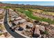 This aerial view looks over the home and the neighboring golf course and community at 41921 N Crooked Stick Rd, Anthem, AZ 85086