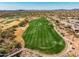 Expansive aerial view of the golf course showcasing the lush green fairway with beautiful desert landscape at 41921 N Crooked Stick Rd, Anthem, AZ 85086