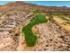 Aerial view of a community with beautiful green golf course and mountain views at 41921 N Crooked Stick Rd, Anthem, AZ 85086