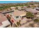 Aerial view of the home featuring a covered patio, desert landscape, and wrought iron fence at 41921 N Crooked Stick Rd, Anthem, AZ 85086