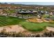 Scenic aerial view of the golf course and resort featuring lush greenery, pristine fairways, and a luxurious clubhouse at 41921 N Crooked Stick Rd, Anthem, AZ 85086