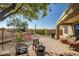 Desert backyard featuring a built-in firepit and wrought iron fence at 41921 N Crooked Stick Rd, Anthem, AZ 85086