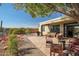 Desert backyard featuring a built-in firepit, grill, covered patio and wrought iron fence at 41921 N Crooked Stick Rd, Anthem, AZ 85086