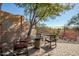 Paver-stone patio with seating area and desert landscape beyond a wrought iron fence at 41921 N Crooked Stick Rd, Anthem, AZ 85086