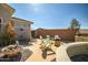 A cozy backyard patio featuring desert landscaping, flagstone pavers, and a charming outdoor seating area at 41921 N Crooked Stick Rd, Anthem, AZ 85086