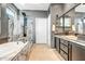 Modern bathroom featuring a soaking tub, glass enclosed shower and double sink vanity at 41921 N Crooked Stick Rd, Anthem, AZ 85086