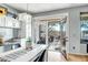 Bright breakfast nook featuring white cabinets, granite countertops and a glass door out to the covered patio at 41921 N Crooked Stick Rd, Anthem, AZ 85086