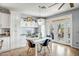 Bright dining area featuring access to the back patio, white cabinetry, and stylish decor at 41921 N Crooked Stick Rd, Anthem, AZ 85086