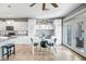 Charming dining area with white cabinetry, a black and white table, and access to a sunny outdoor space at 41921 N Crooked Stick Rd, Anthem, AZ 85086