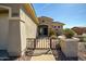 Close-up of the front entrance featuring a gated entry and desert landscaping at 41921 N Crooked Stick Rd, Anthem, AZ 85086