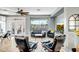 Modern living room featuring comfortable seating, a ceiling fan, and a large window showcasing the outdoor view at 41921 N Crooked Stick Rd, Anthem, AZ 85086