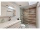 Modern bathroom with stone countertops, a wood-look shower, and illuminated vanity mirror at 4201 E Camelback Rd # 34, Phoenix, AZ 85018