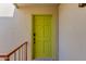 Inviting front entrance featuring a vibrant door, textured wall, and iron railing at 4201 E Camelback Rd # 34, Phoenix, AZ 85018