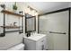 Updated bathroom features a sliding glass shower door and industrial style shelving at 4203 N 36Th St # 23, Phoenix, AZ 85018