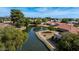 Aerial shot of waterfront community showcasing mature trees, walking paths, and scenic pond at 421 Leisure World --, Mesa, AZ 85206